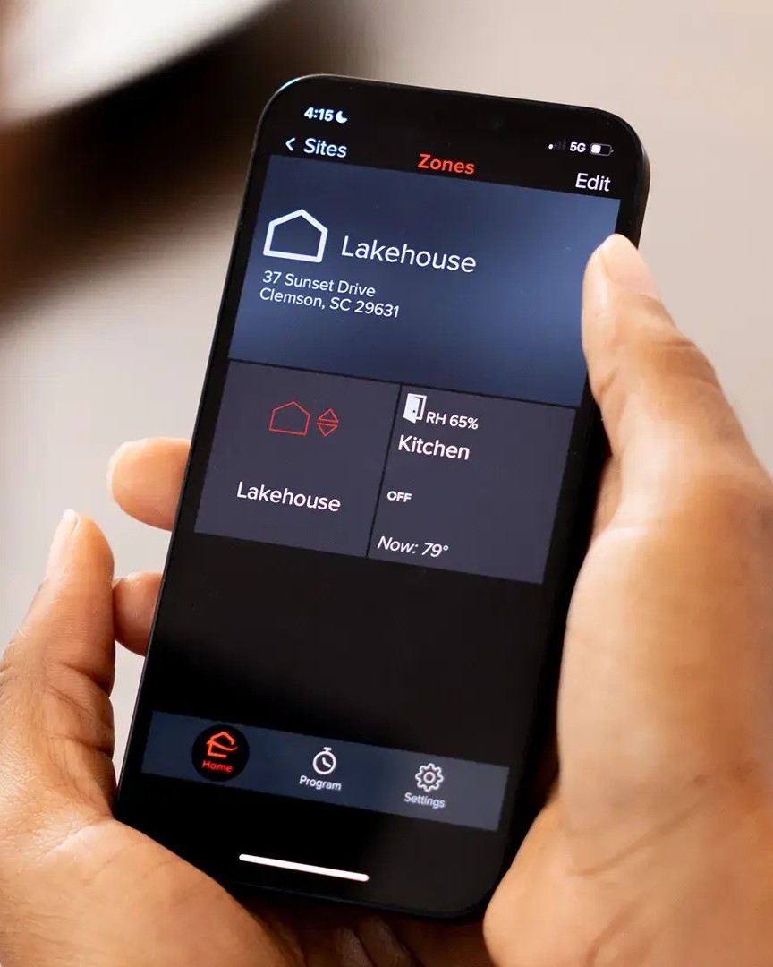 A smartphone screen displaying a smart air conditioning control app, allowing remote management of home climate settings.