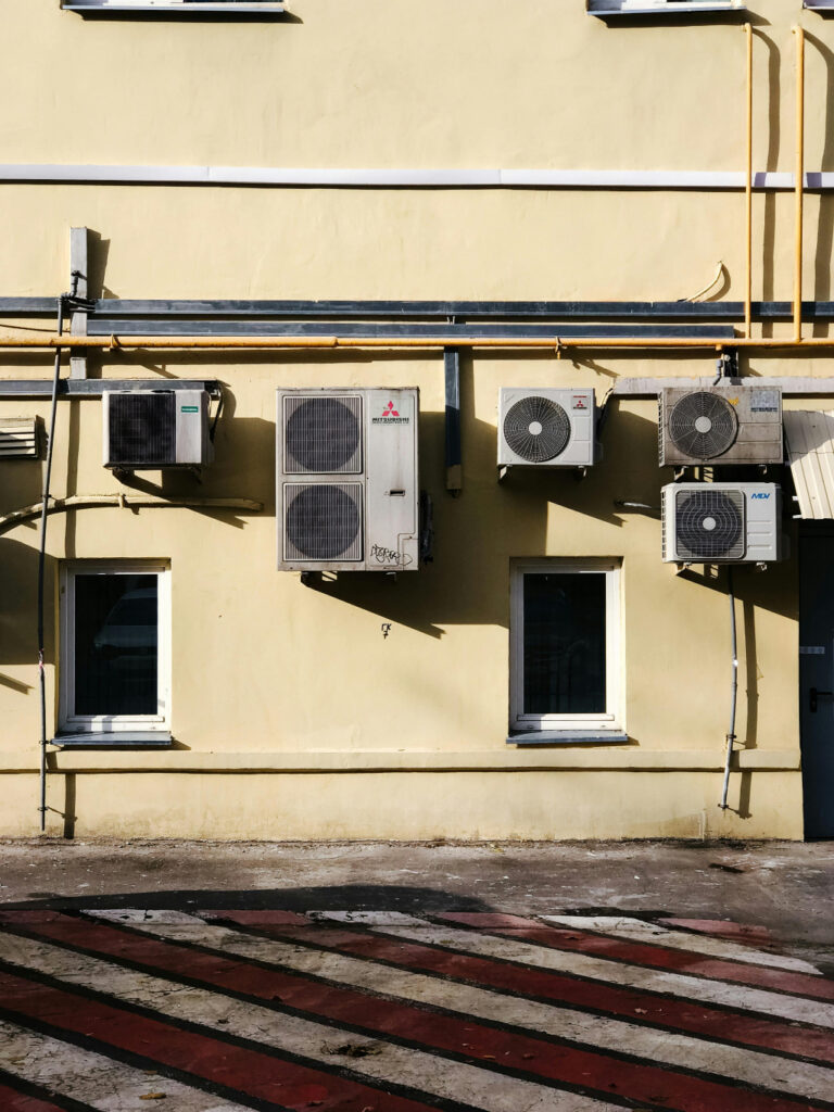 Mitsubishi condenser unit on the outer wall of a wall along with several others