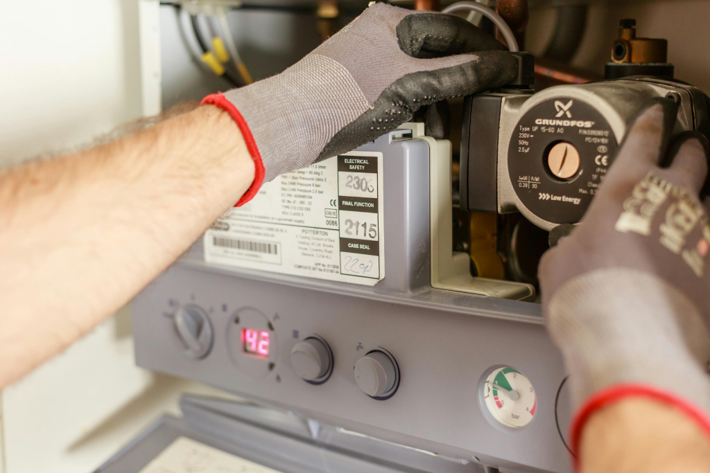 Technician checking on the internals of a heat pump system