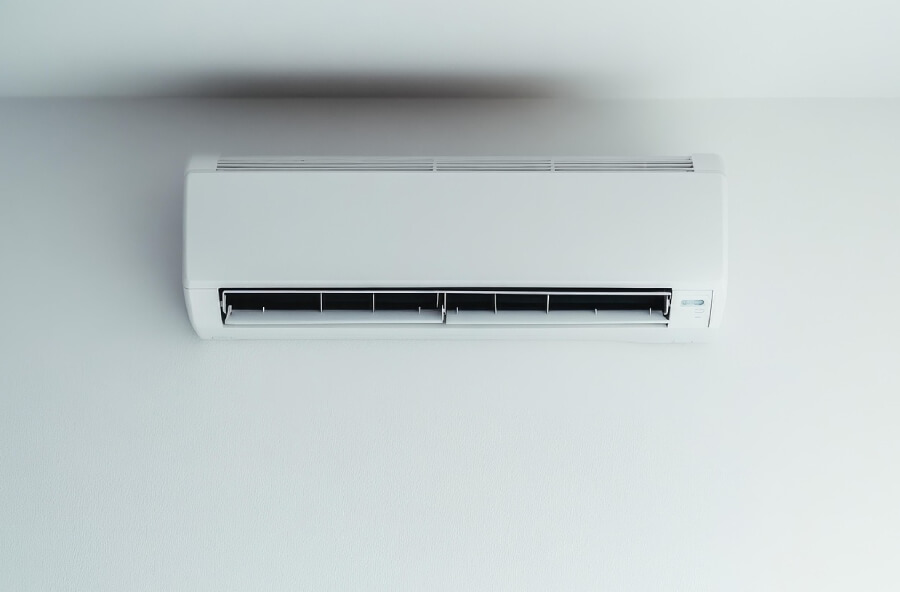 Indoor unit of an air conditioning system against a white wall